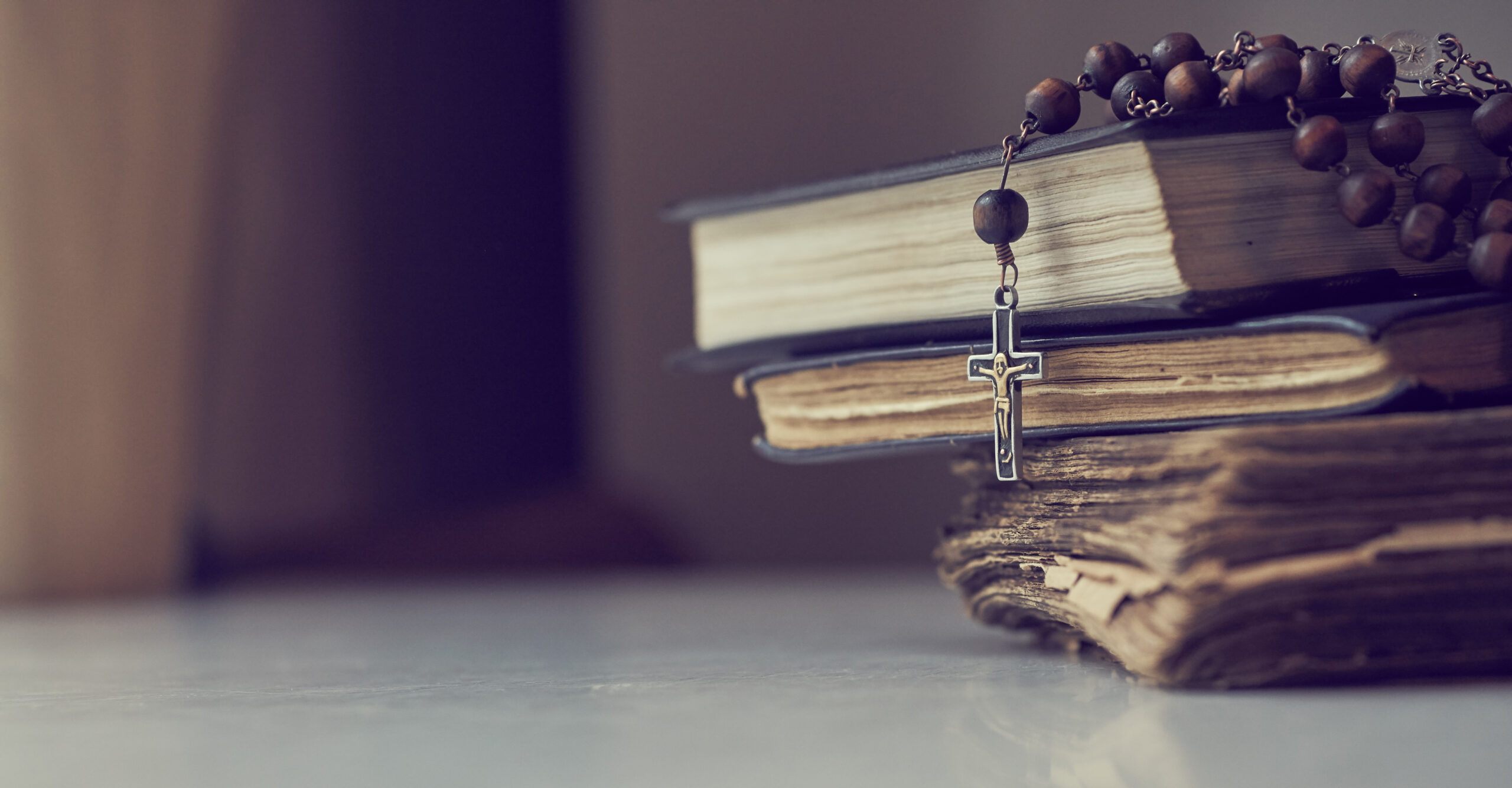 The rosary beads on Catholic Church liturgy books.