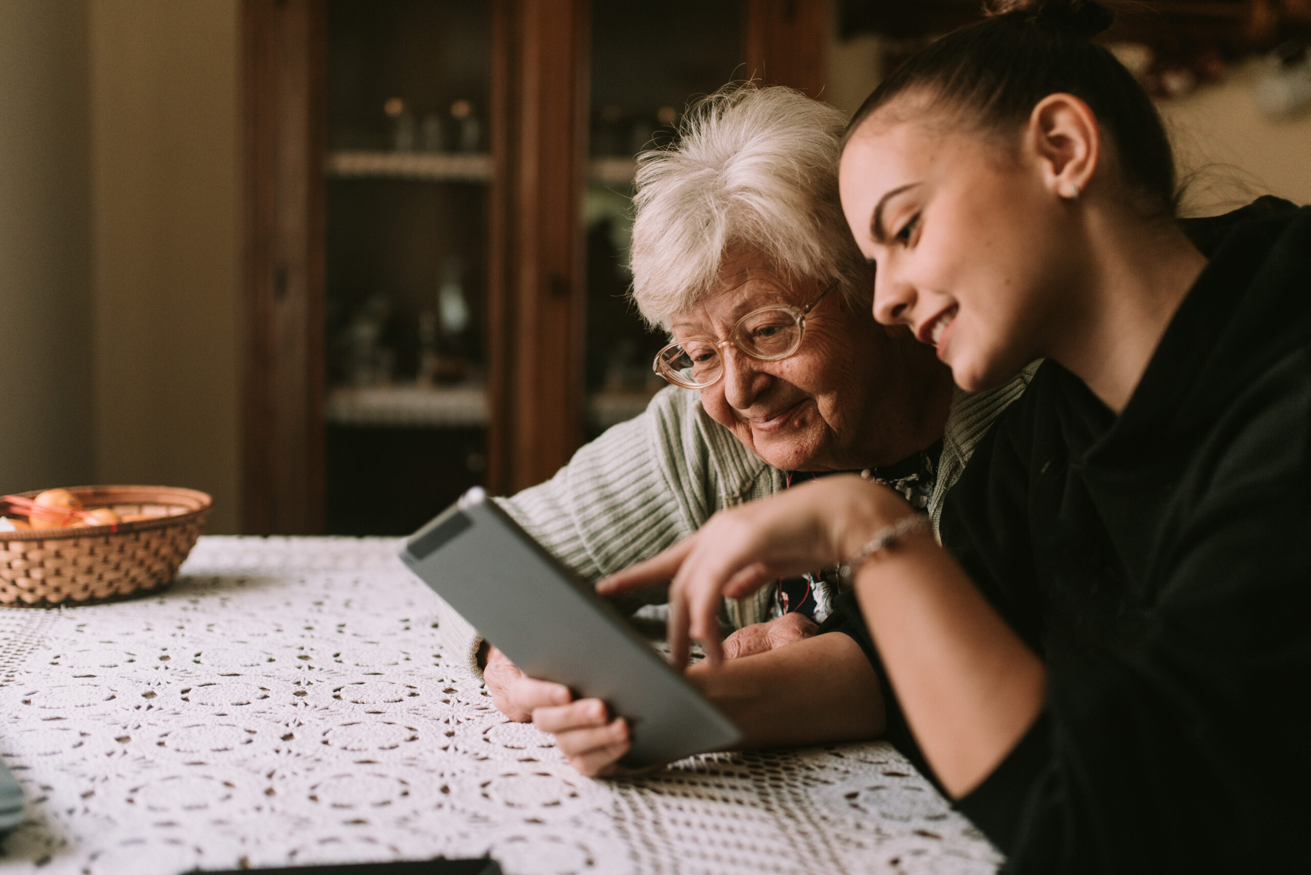 Smiling caucasian grandmother and beautiful granddaughter in the